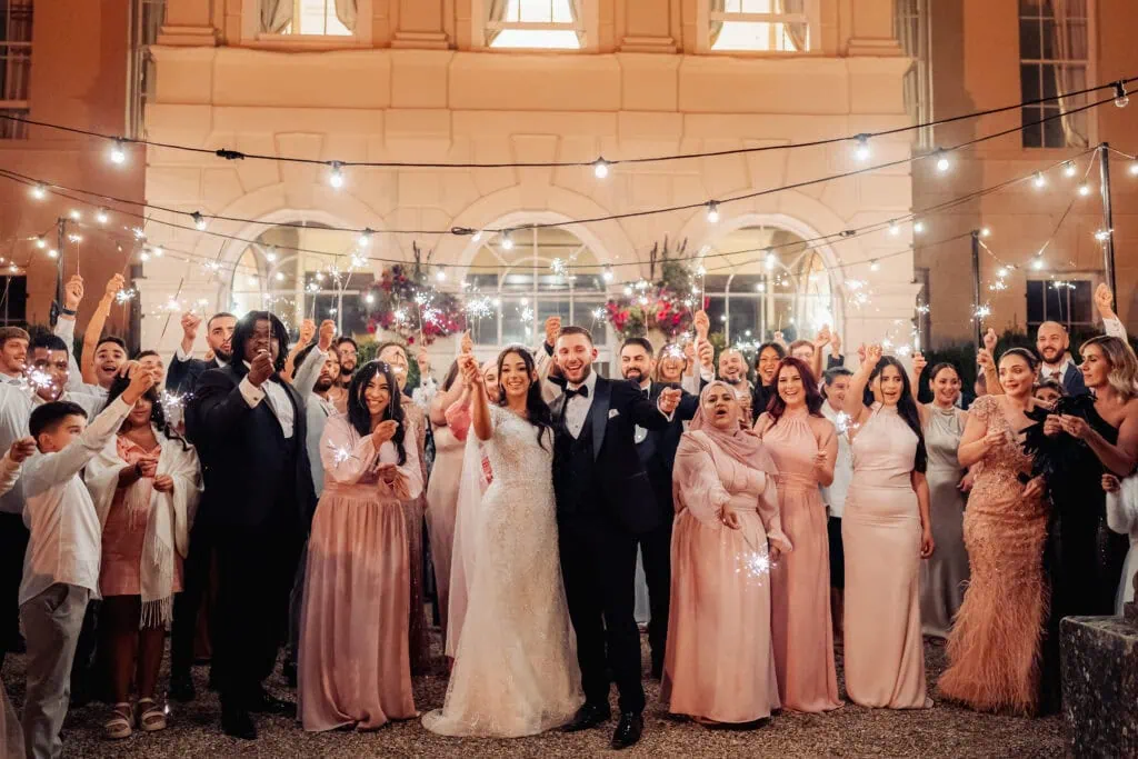 Wedding party dressed in pastel colours with sparklers