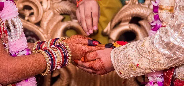Bride and groom holding hands
