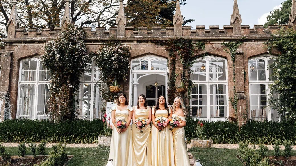 A bridal party all wearing cream dresses