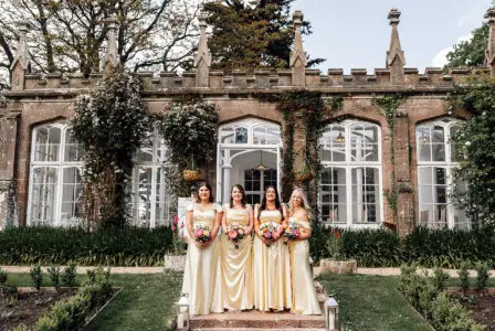A bridal party all wearing cream dresses