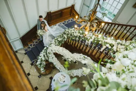 Flowers on a staircase at Gosfield Hall wedding venue